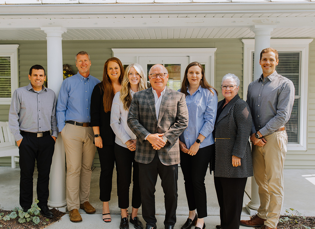 About Our Agency - The AIC Insurance Services Group Standing Together in Front of Their Office